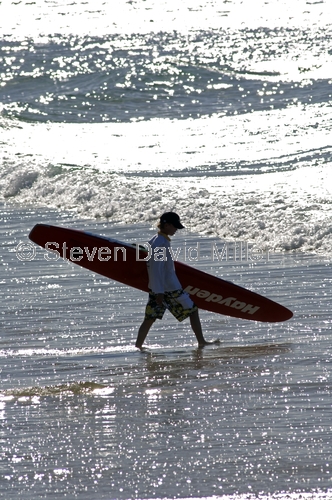 coolangatta beach;gold coast;queensland gold coast;boy with surfboard;walking with surfboard;queensland surfer