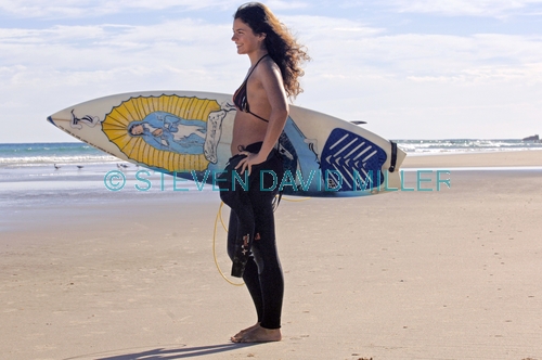 woman with surfboard;woman surfer;woman carrying surfboard;woman surfer;female surfer;byron bay surfer