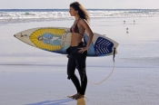 woman-on-surfboard;woman-surfer;woman-lying-on-surfboard;woman-paddling-surfboard;byron-bay-surfer